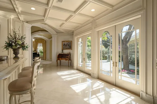 a kitchen with stainless steel appliances granite countertop a sink and a view of living room