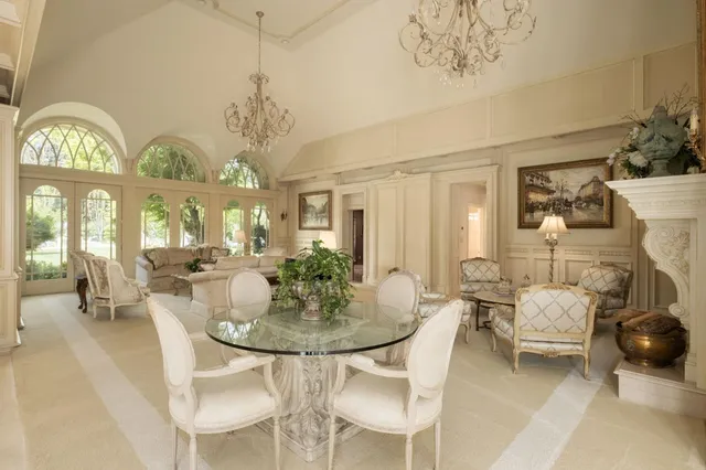 a view of a dining room with furniture and a chandelier