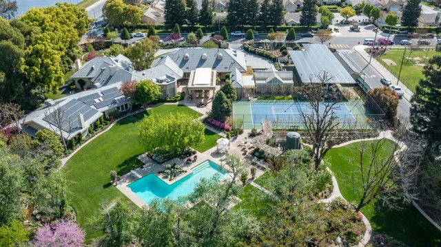 an aerial view of residential house with outdoor space and swimming pool