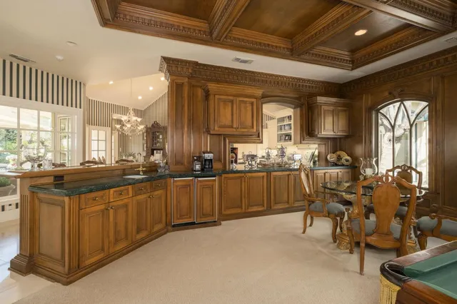 a spacious bathroom with a granite countertop sink a toilet a mirror and shower