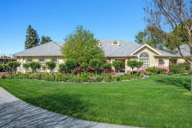 a front view of a house with garden