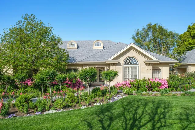 a front view of a house with a yard