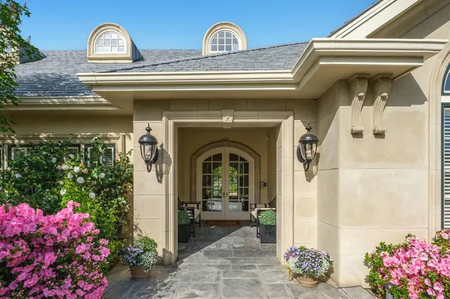 a living room with furniture a fireplace and a chandelier