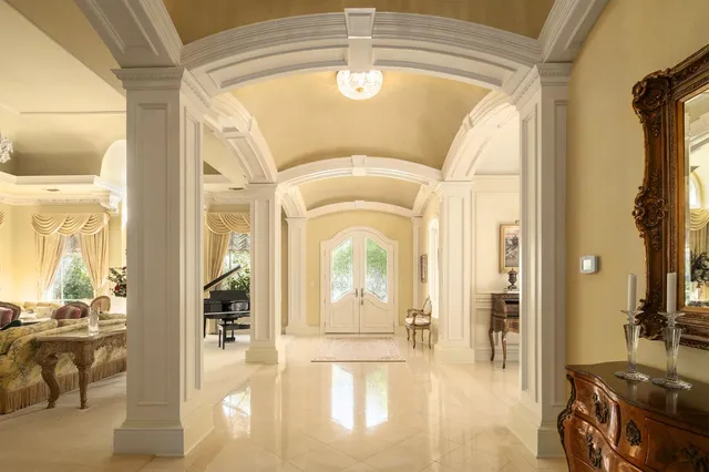 a view of a patio with couches table and chairs and potted plants