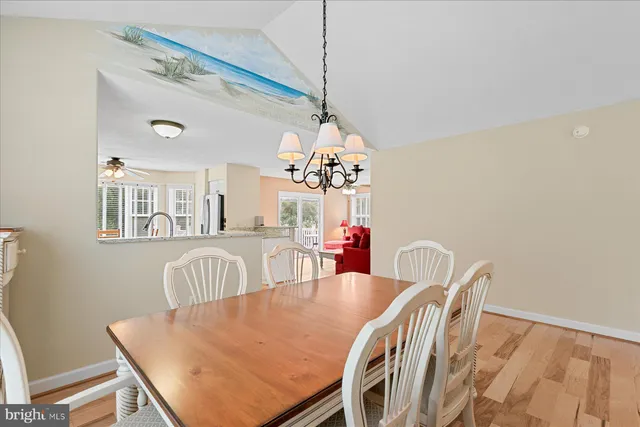 a view of a dining room with furniture and a chandelier