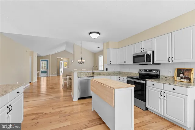 a kitchen with a stove top oven sink and cabinets