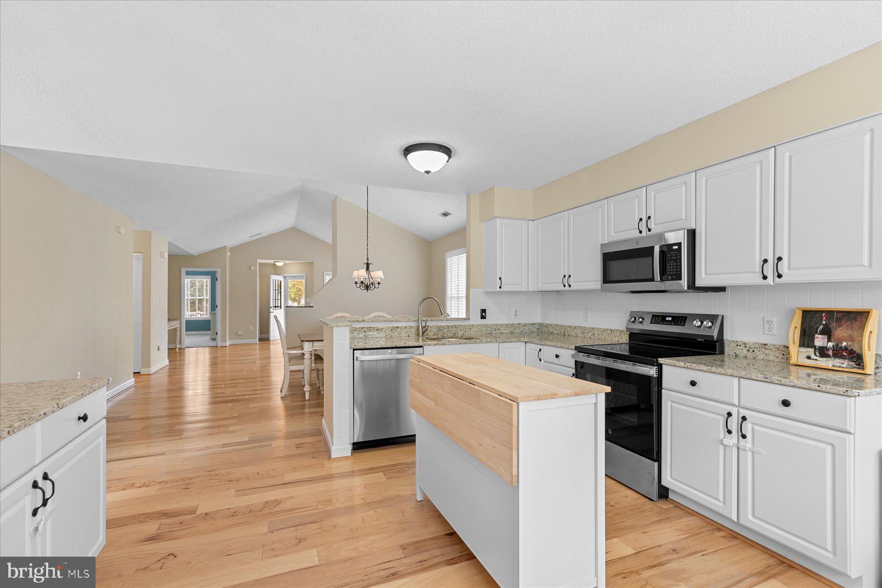 11 Amanda's Court Ocean View, DE 19970 - Photo 13 of 42 a kitchen with a stove top oven sink and cabinets
