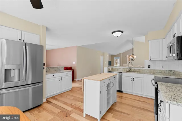 a kitchen with a sink stove and refrigerator