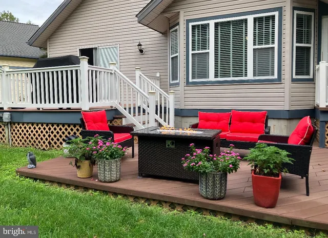 a balcony with wooden floor and furniture