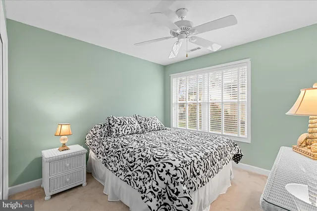 a bedroom with a bed and a lamp