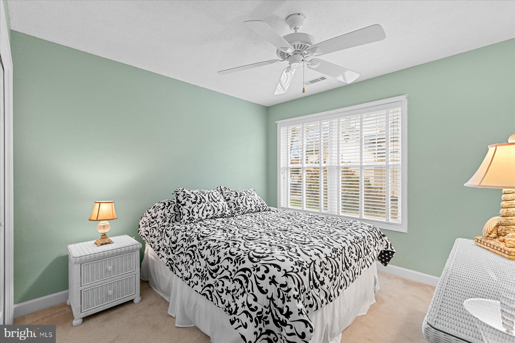 11 Amanda's Court Ocean View, DE 19970 - Photo 32 of 42 a bedroom with a bed and a chandelier