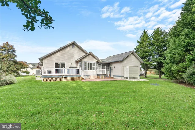a view of swimming pool with lawn chairs and plants