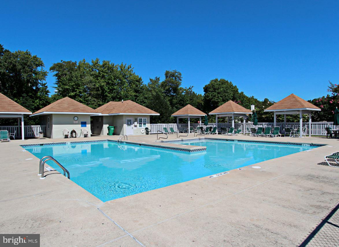 11 Amanda's Court Ocean View, DE 19970 - Photo 42 of 42 a view of swimming pool with lawn chairs and plants