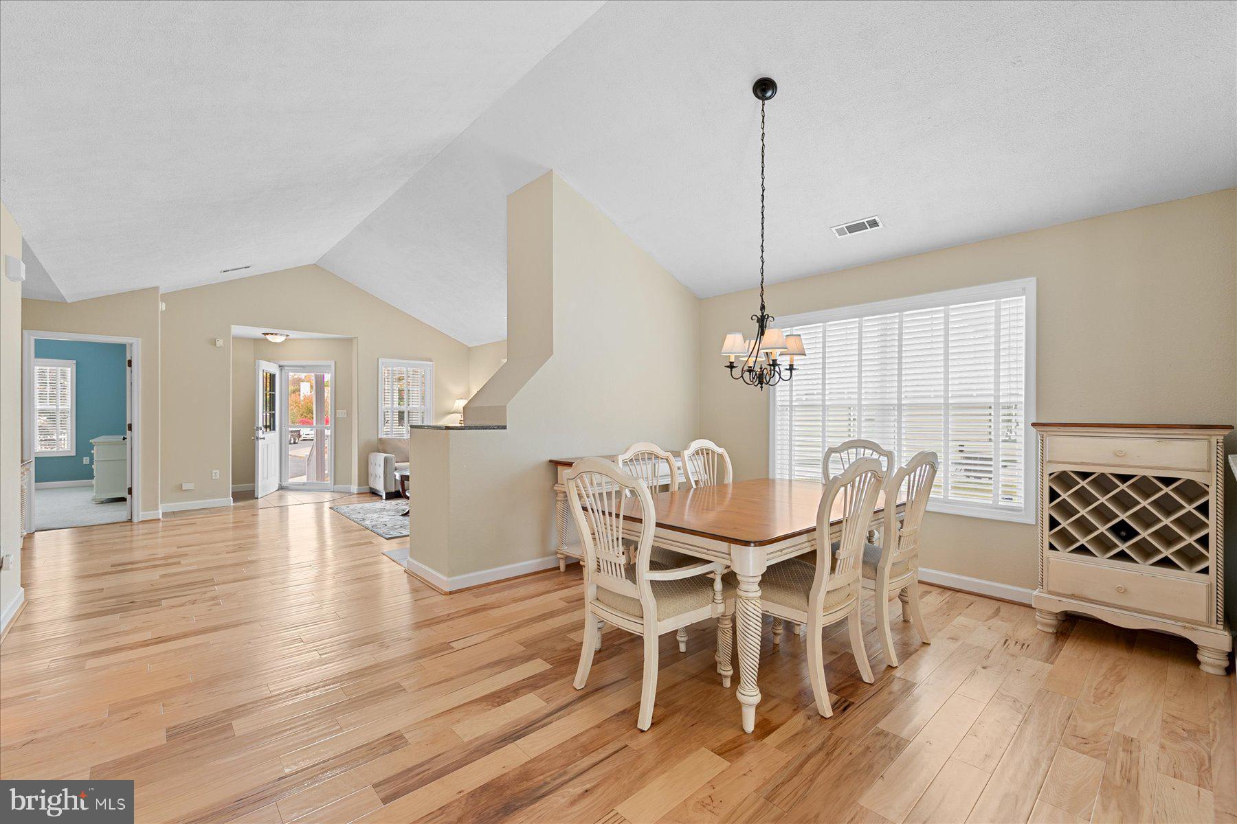 11 Amanda's Court Ocean View, DE 19970 - Photo 10 of 42 a dining room with furniture wooden floor a rug and a chandelier