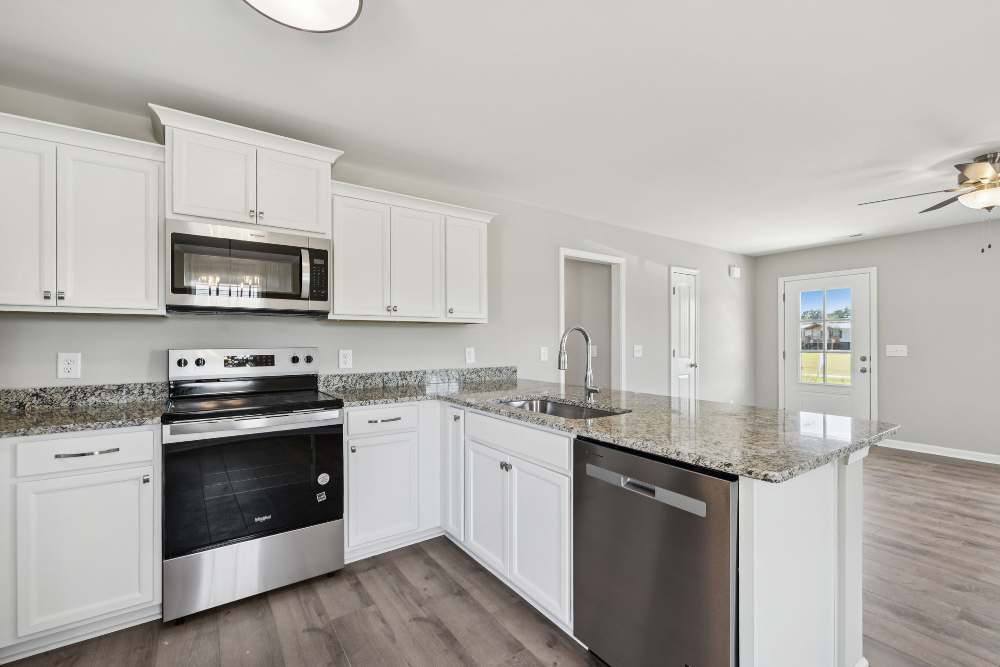 84 Old Brick Church Road Estill Springs, TN 37330 - Photo 15 of 37 a kitchen with stainless steel appliances granite countertop a sink stove and microwave