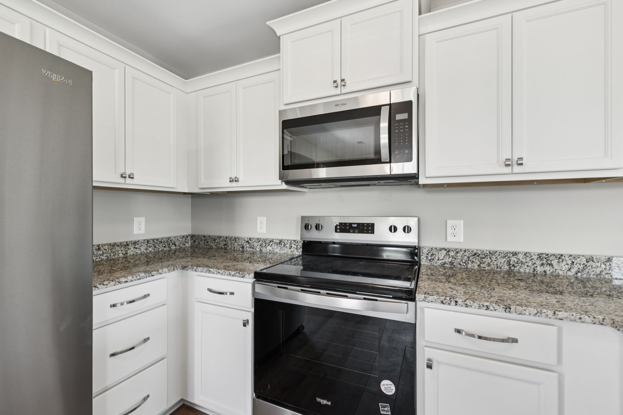 84 Old Brick Church Road Estill Springs, TN 37330 - Photo 16 of 37 a kitchen with white cabinets and appliances