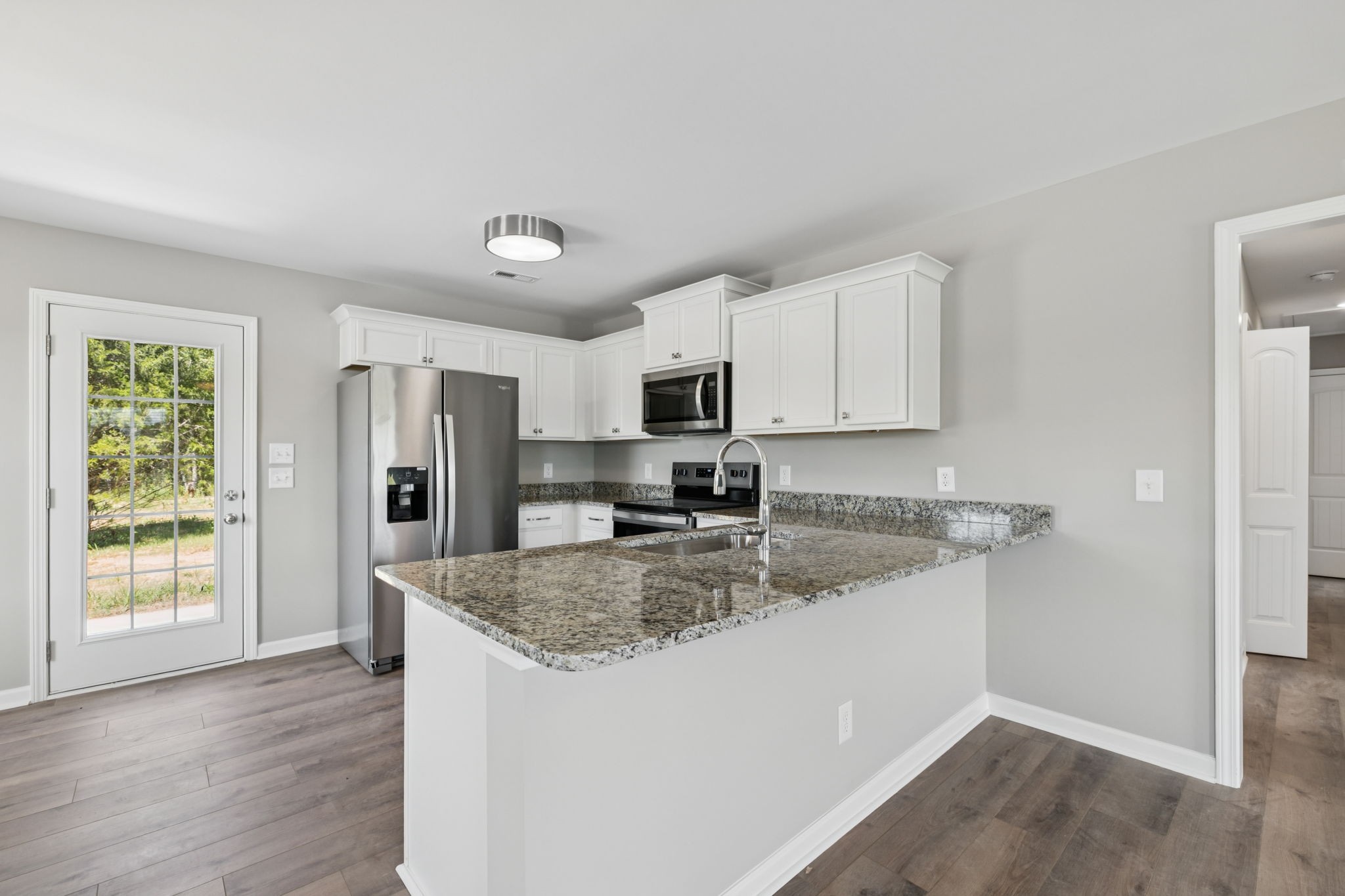 84 Old Brick Church Road Estill Springs, TN 37330 - Photo 17 of 37 a kitchen with stainless steel appliances granite countertop a sink dishwasher and a refrigerator with wooden floor