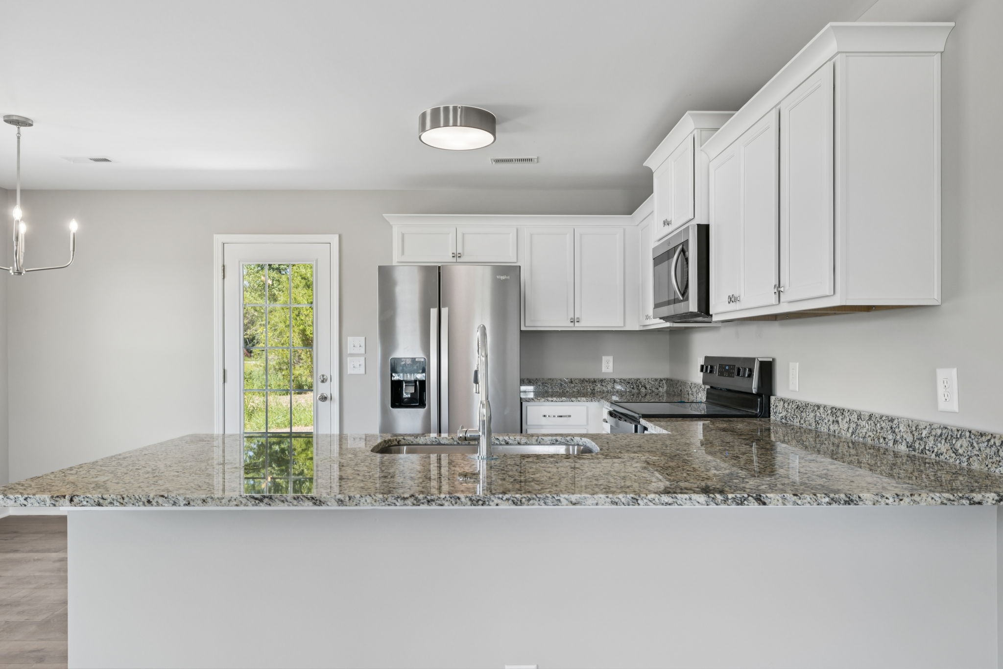 84 Old Brick Church Road Estill Springs, TN 37330 - Photo 18 of 37 a kitchen with stainless steel appliances granite countertop a sink and cabinets