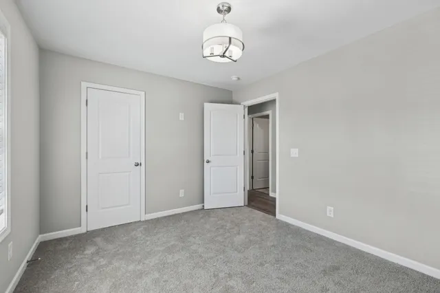 a bathroom with a window and a shower