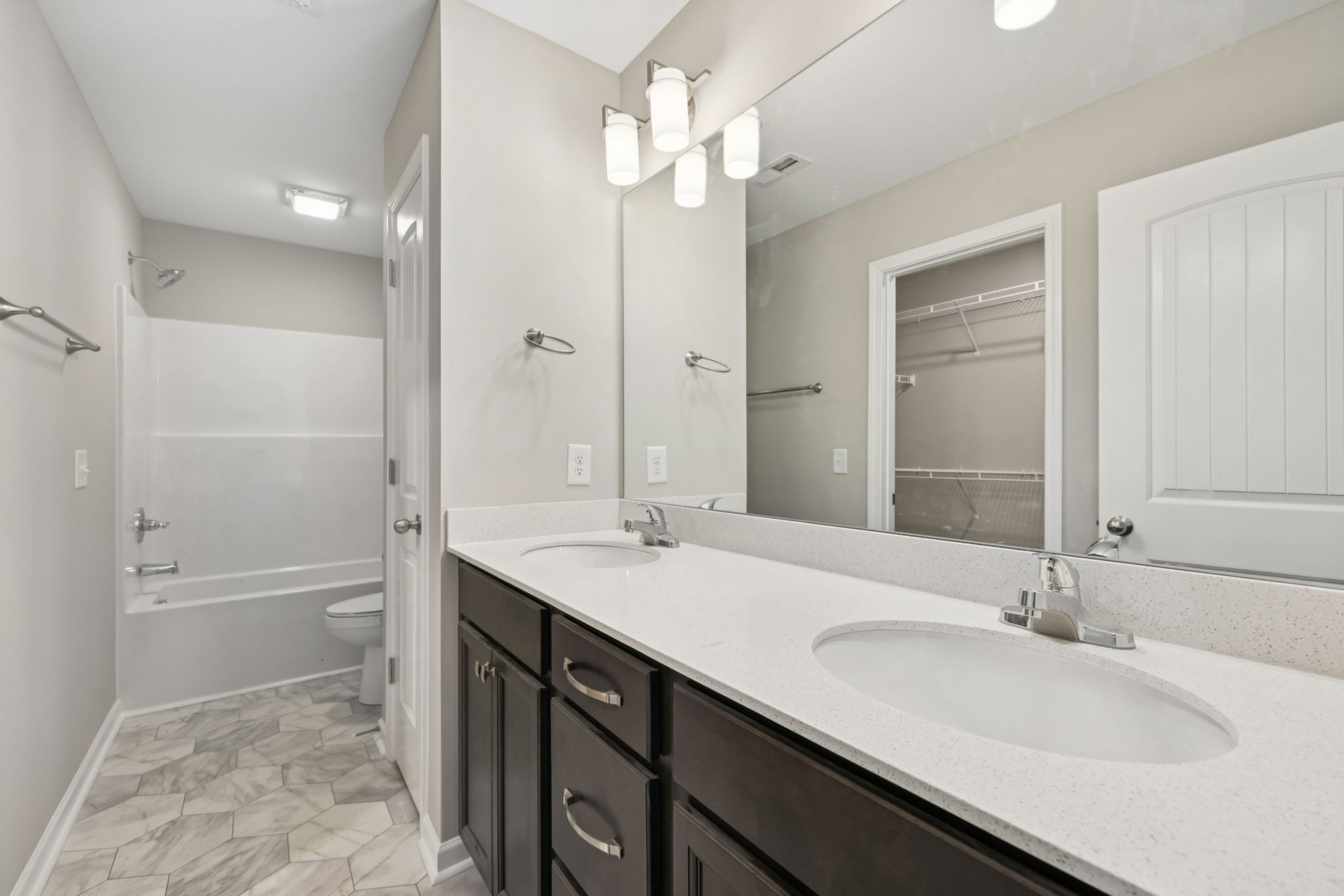 84 Old Brick Church Road Estill Springs, TN 37330 - Photo 28 of 37 a bathroom with a granite countertop sink a toilet a mirror and shower