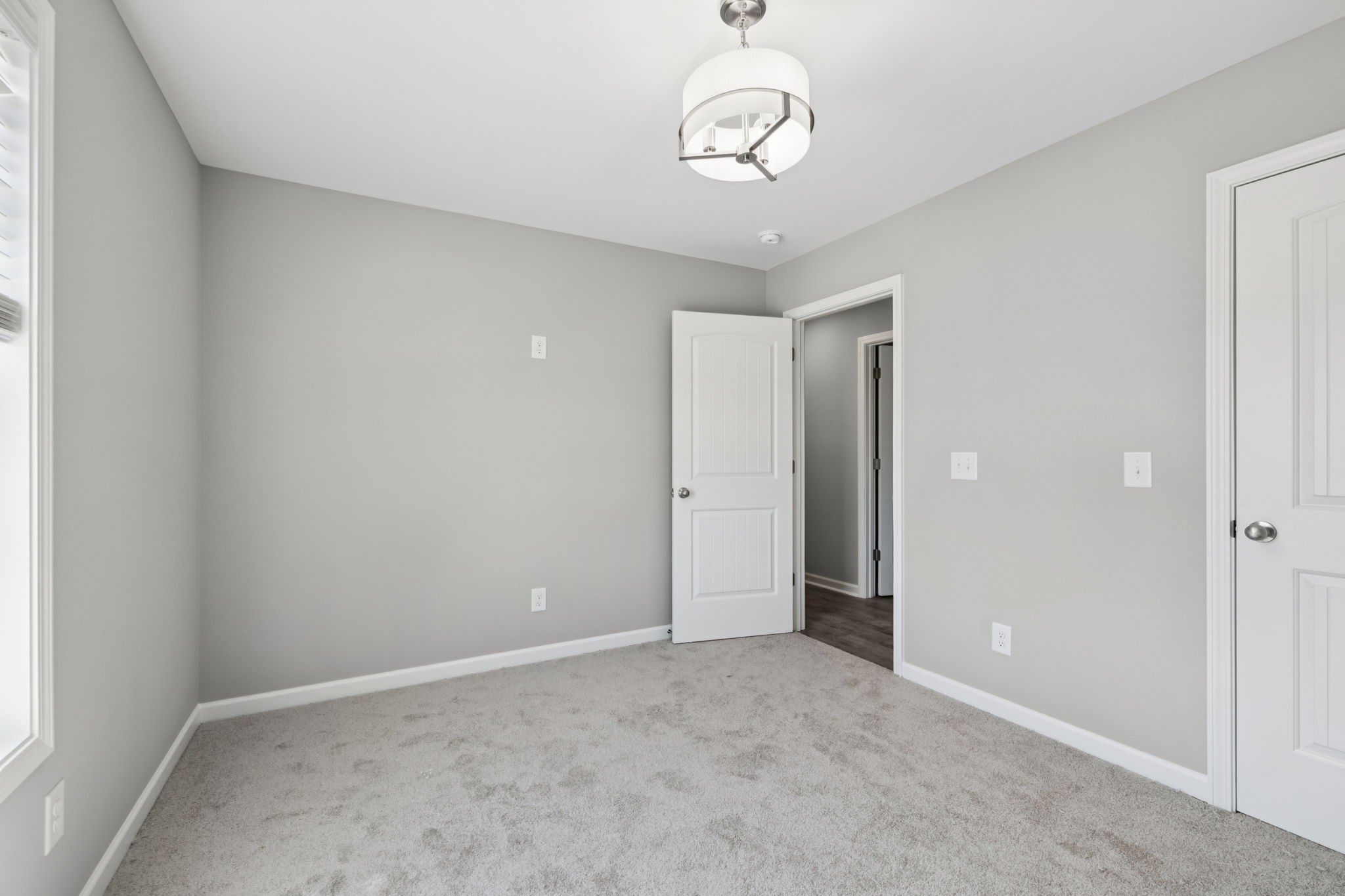 84 Old Brick Church Road Estill Springs, TN 37330 - Photo 32 of 37 an empty room with a chandelier and a chandelier fan