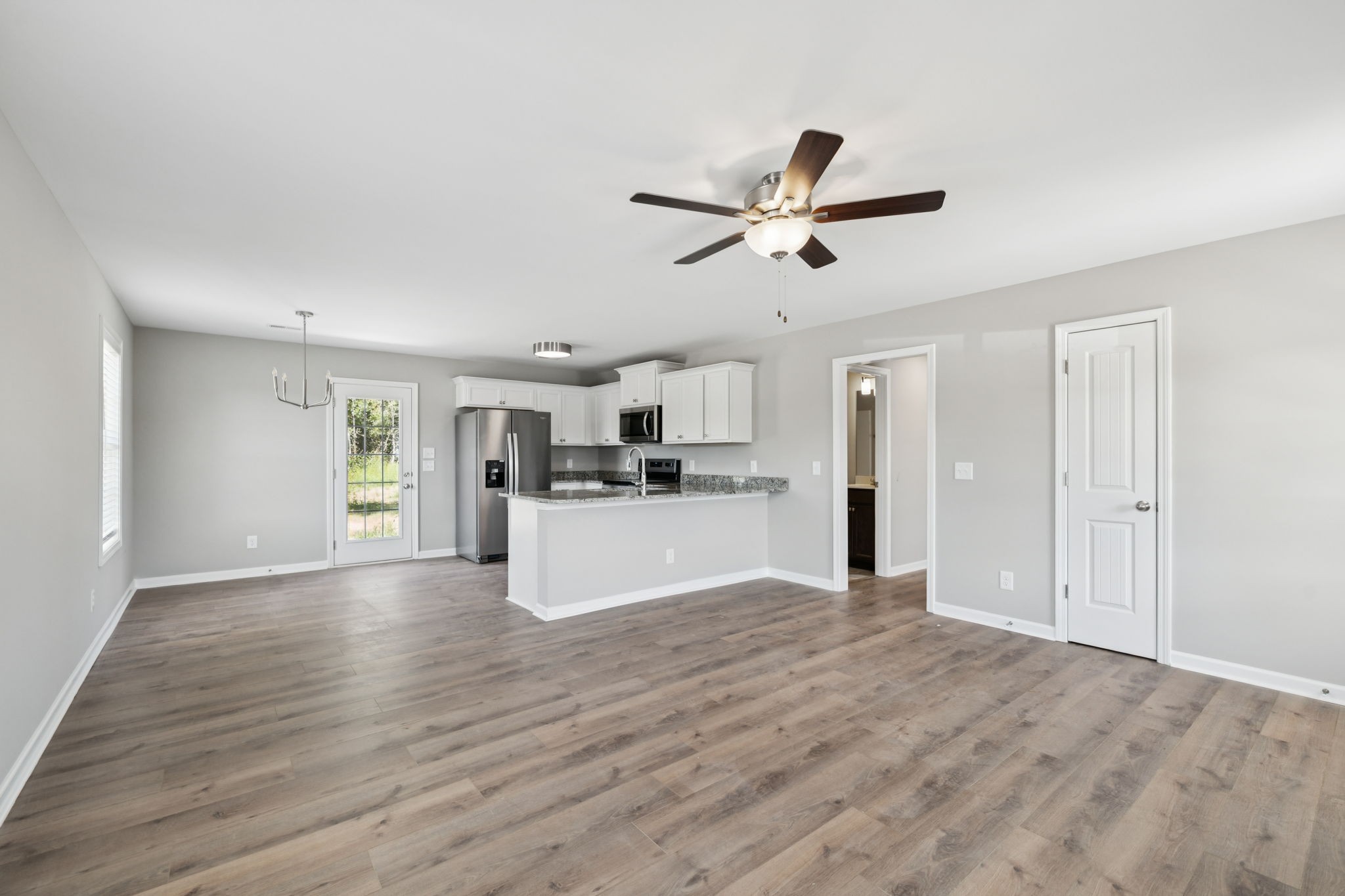 84 Old Brick Church Road Estill Springs, TN 37330 - Photo 9 of 37 a view of a kitchen with a sink and dishwasher a refrigerator with wooden floor