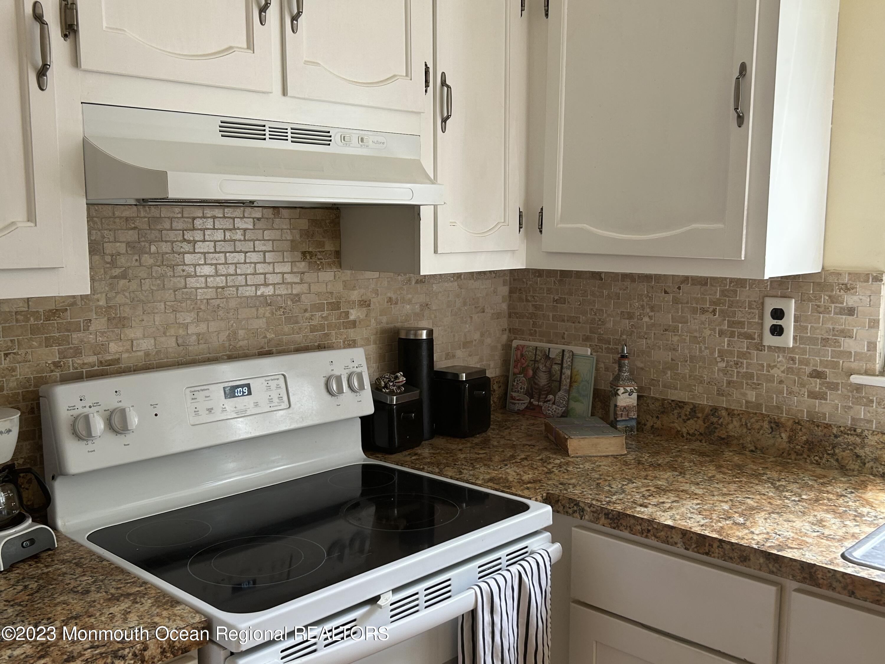 51 Markham Road Brick, NJ 08724 - Photo 12 of 31 a kitchen with granite countertop white cabinets and white appliances
