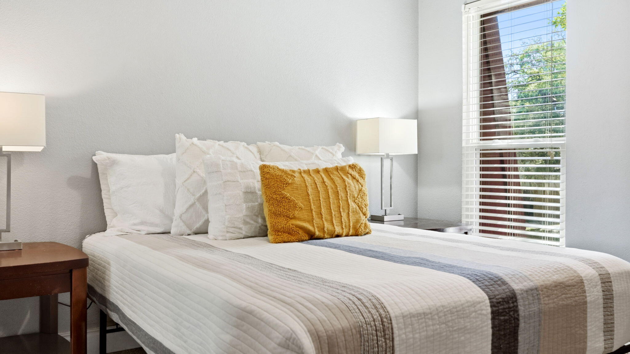 210 Pelham Road, Unit 215A Fort Walton Beach, FL 32547 - Photo 12 of 27 a bedroom with a bed and a lamp