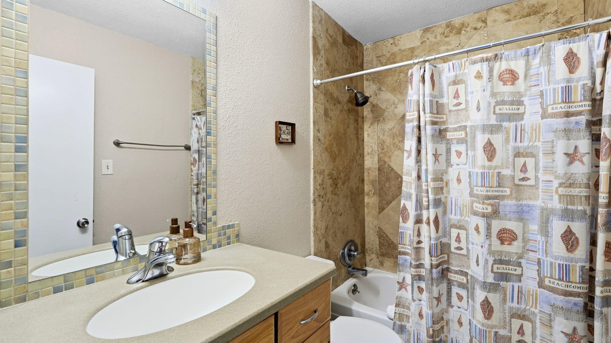 210 Pelham Road, Unit 215A Fort Walton Beach, FL 32547 - Photo 17 of 27 a bathroom with a sink and a mirror