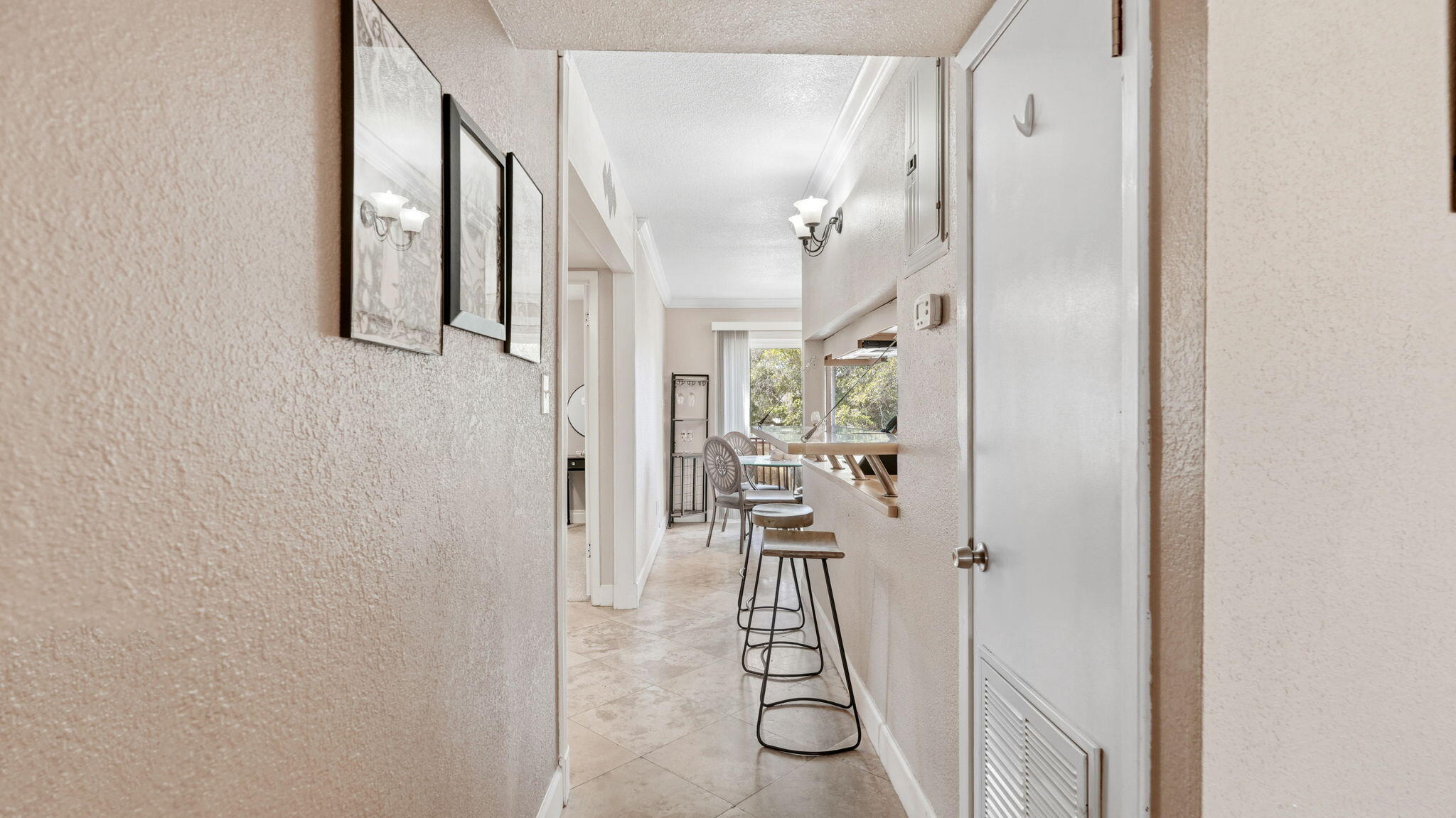 210 Pelham Road, Unit 215A Fort Walton Beach, FL 32547 - Photo 7 of 27 a view of a hallway with a livingroom and a painting on the wall