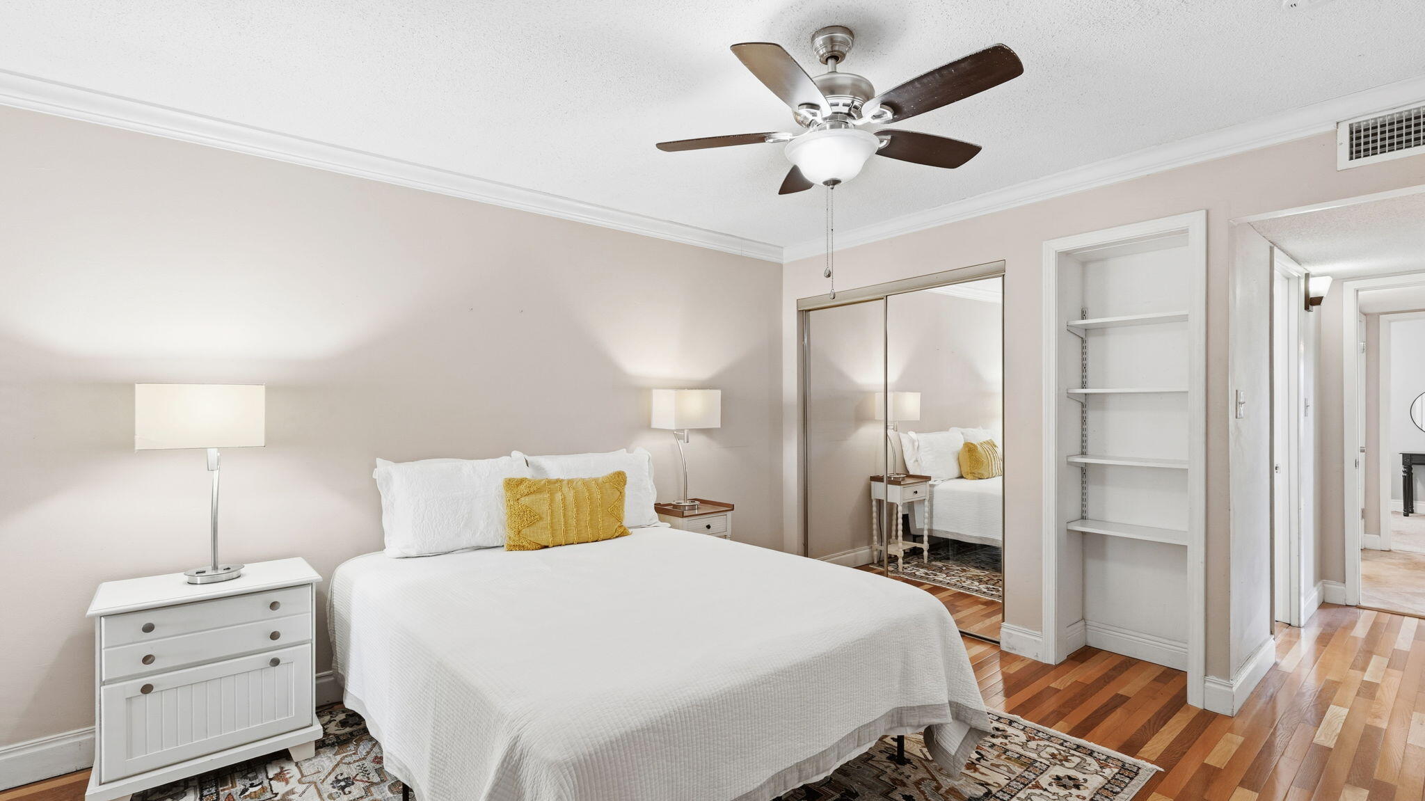 210 Pelham Road, Unit 215A Fort Walton Beach, FL 32547 - Photo 9 of 27 a bedroom with a bed and a lamp on dresser