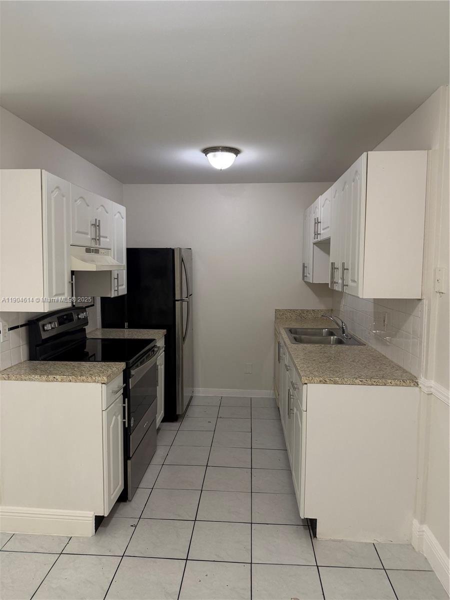 10370 Southwest 220th Street, Unit 118 Cutler Bay, FL 33190 - Photo 1 of 15 a kitchen with stainless steel appliances granite countertop a sink stove and refrigerator