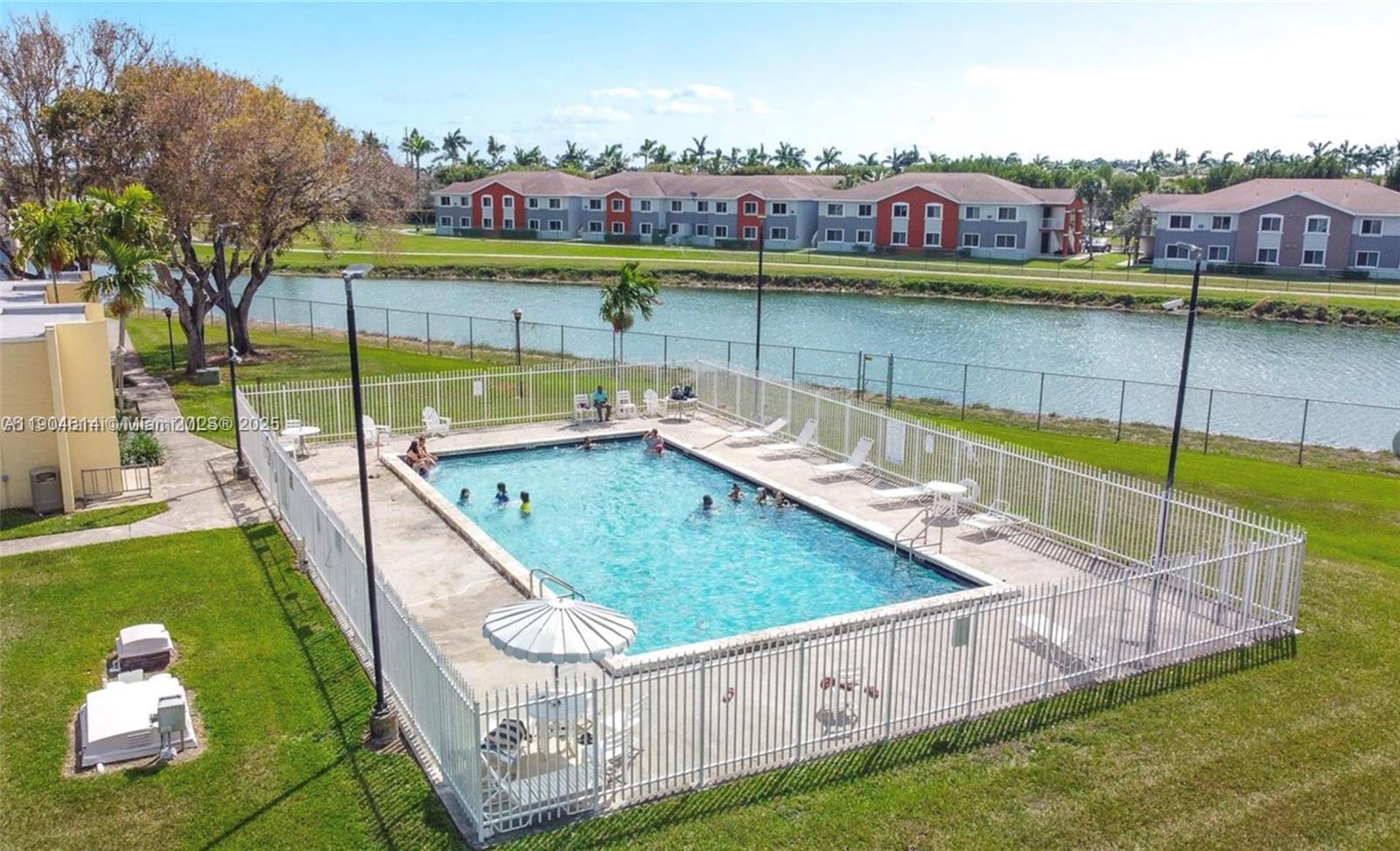 10370 Southwest 220th Street, Unit 118 Cutler Bay, FL 33190 - Photo 15 of 15 a view of swimming pool with a garden and outdoor seating