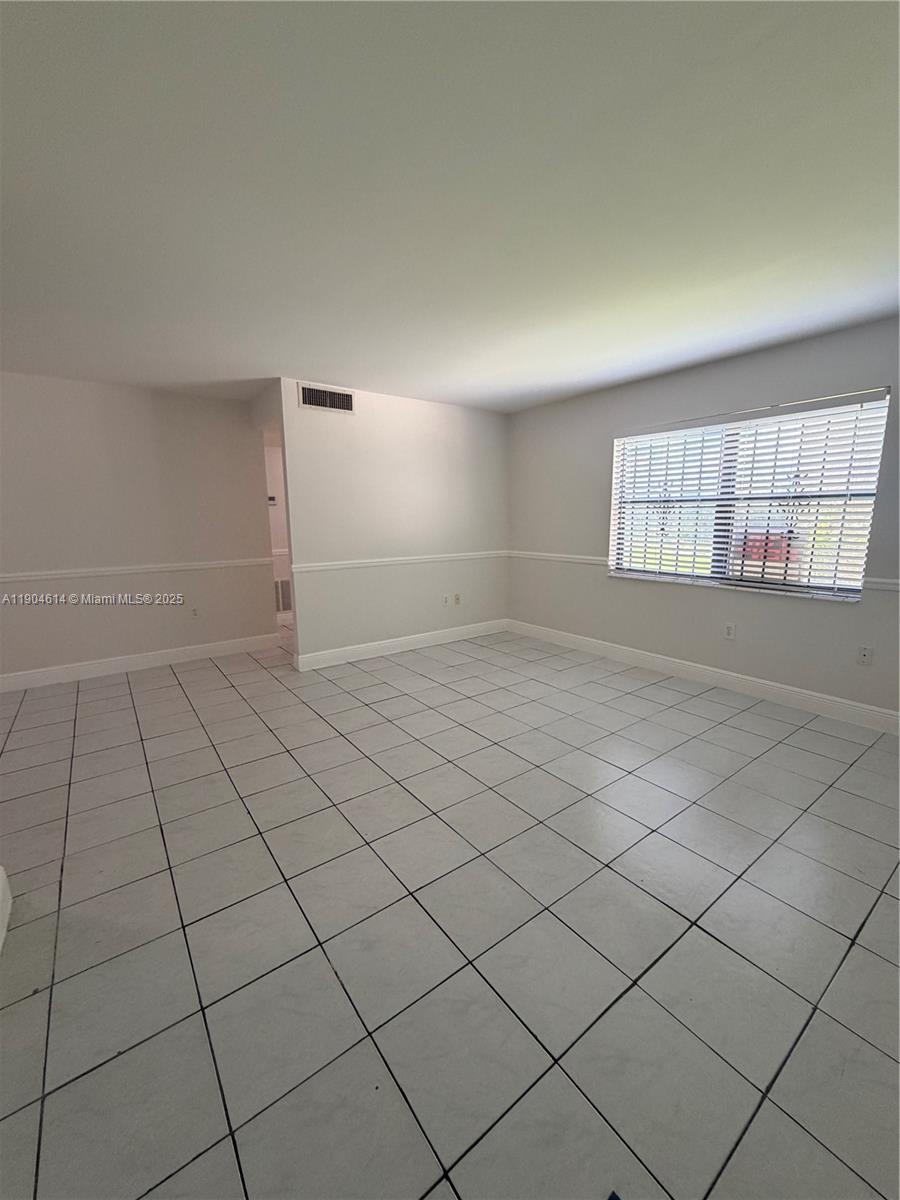 10370 Southwest 220th Street, Unit 118 Cutler Bay, FL 33190 - Photo 5 of 15 a view of an empty room and window
