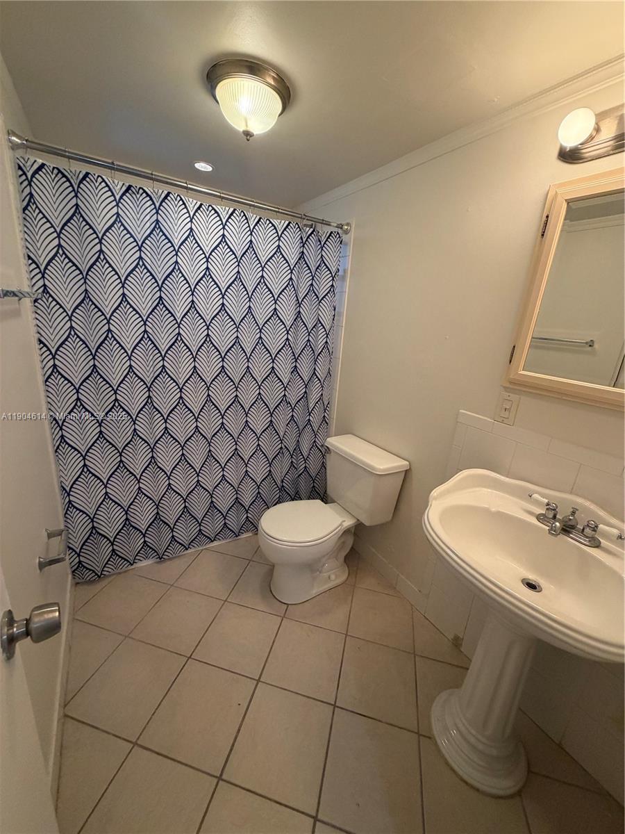 10370 Southwest 220th Street, Unit 118 Cutler Bay, FL 33190 - Photo 8 of 15 a bathroom with a sink and a toilet