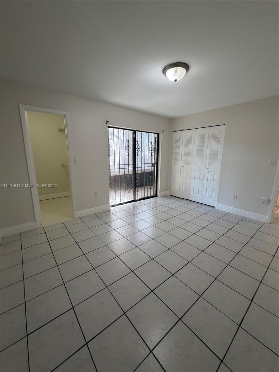 10370 Southwest 220th Street, Unit 118 Cutler Bay, FL 33190 - Photo 10 of 15 a view of an empty room and window