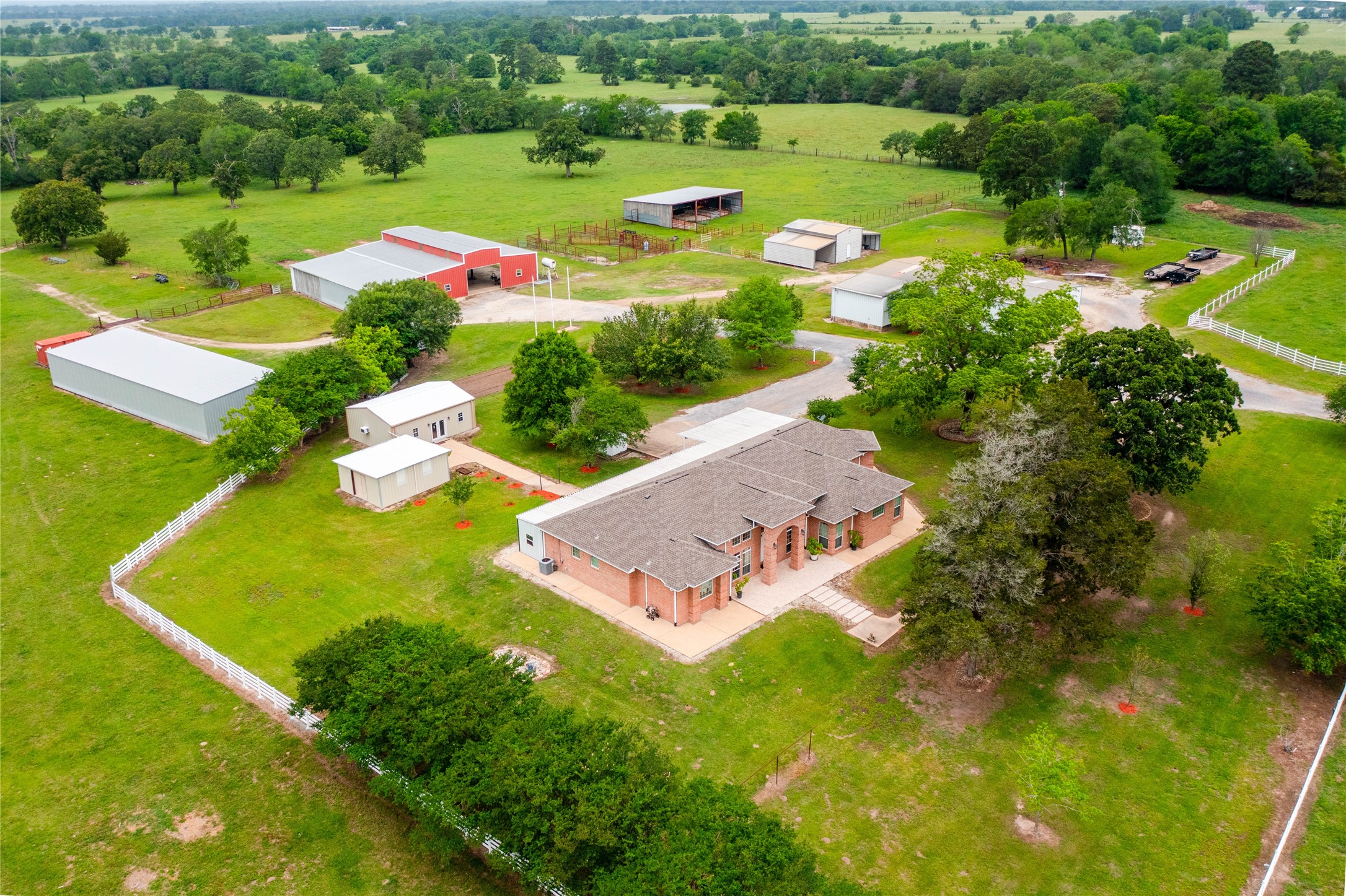 an aerial view of a house with a garden swimming pool and outdoor seating