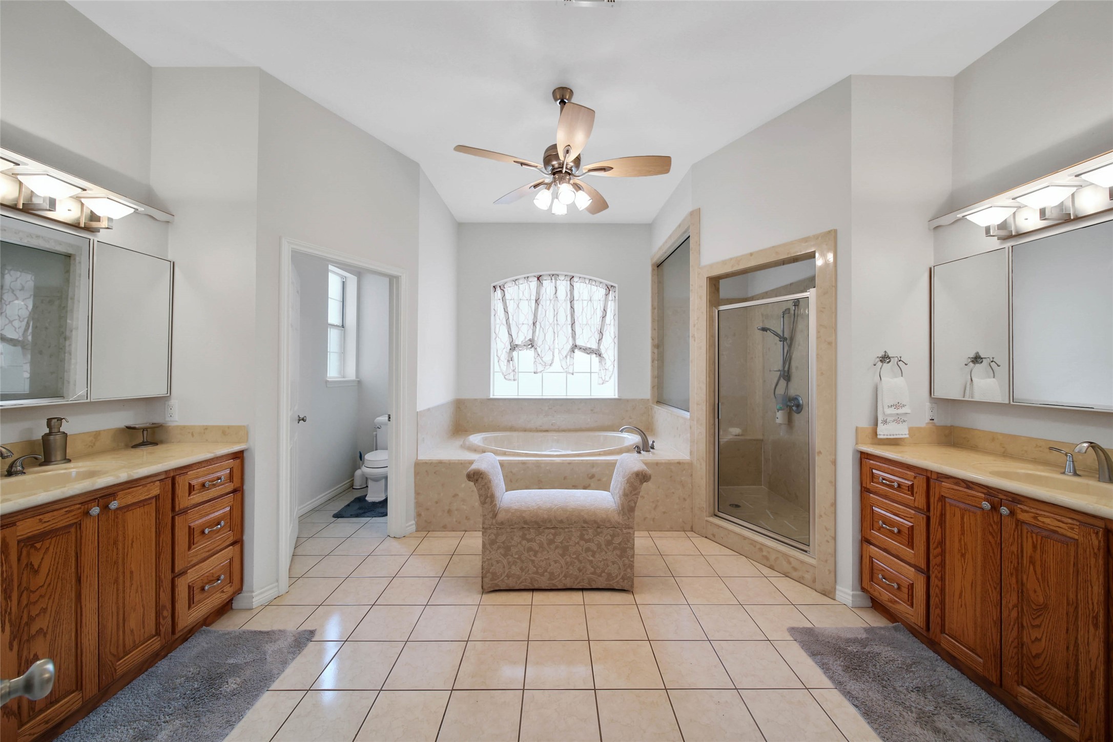 128 Duke Road Bedias, TX 77831 - Photo 20 of 50 a spacious bathroom with a double vanity sink a mirror and a bathtub