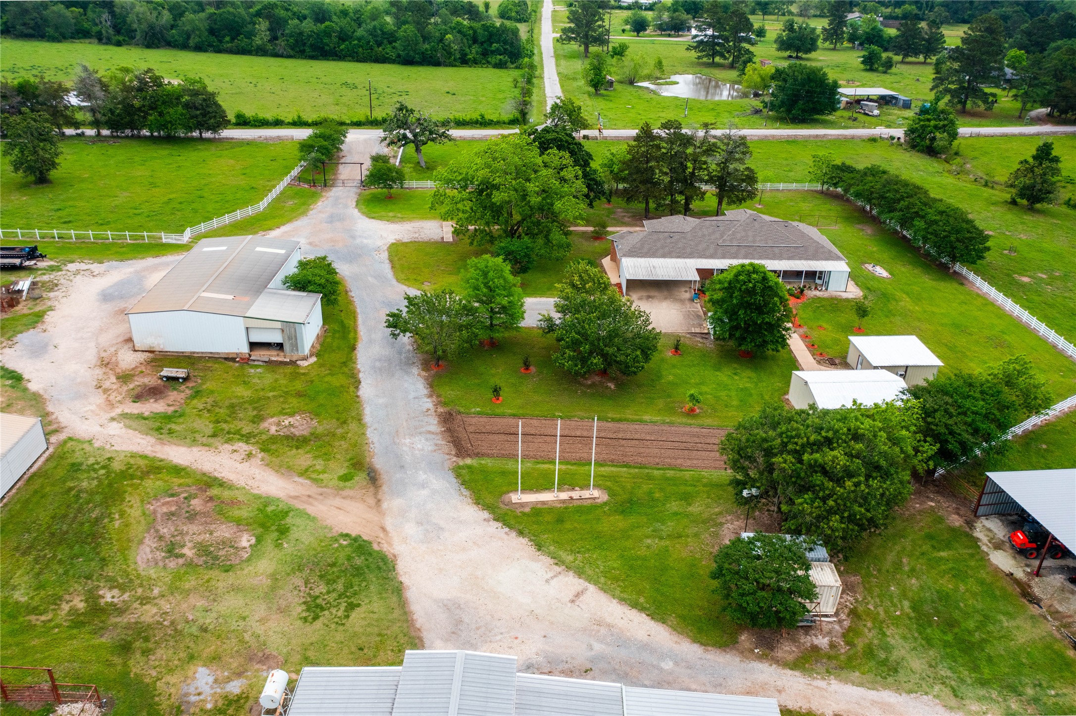 128 Duke Road Bedias, TX 77831 - Photo 7 of 50 an aerial view of a house with a garden and lake view