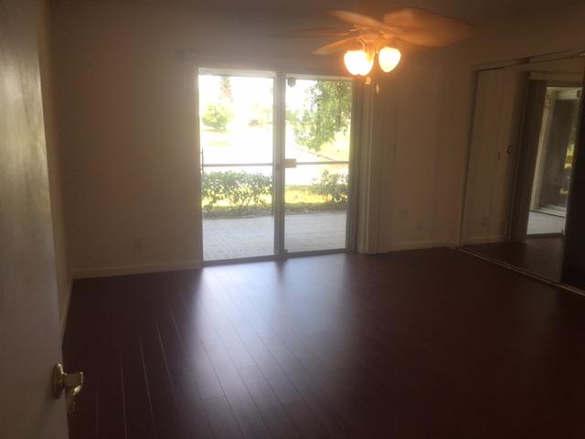 6177 Dusenburg Road Delray Beach, FL 33484 - Photo 6 of 7 a view of an empty room with wooden floor and a window