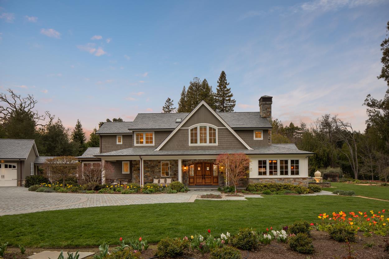 a front view of a house with a garden