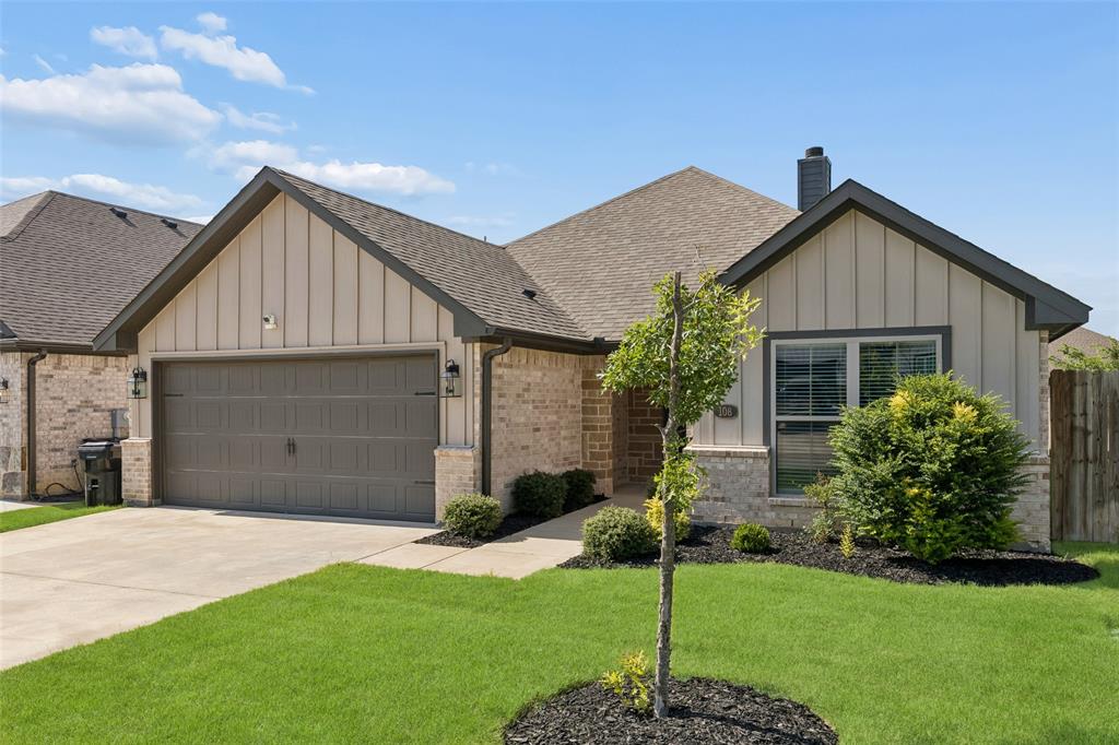 108 Maverick Lane Pilot Point, TX 76258 - Photo 2 of 27 Single-story residence featuring a brick and board-and-batten facade with dark trim