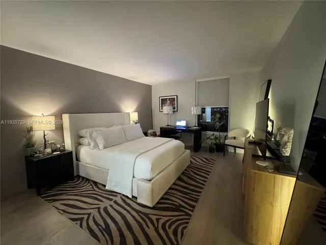 a bedroom with bed and a lamp