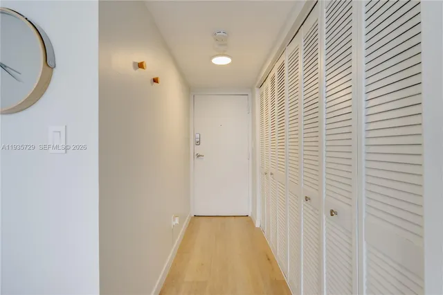 a view of a hallway with wooden floor