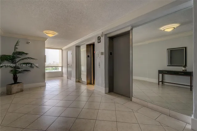 a view of a hallway with closet and a potted plant