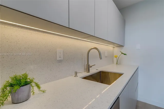 a kitchen with a sink and washing machine