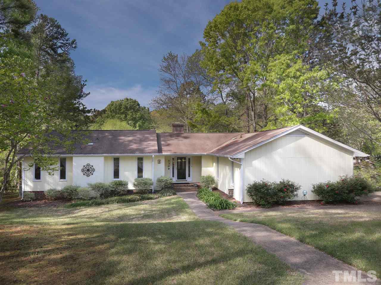 7309 Phellos Court Raleigh, NC 27615 - Photo 2 of 19 a front view of a house with a yard