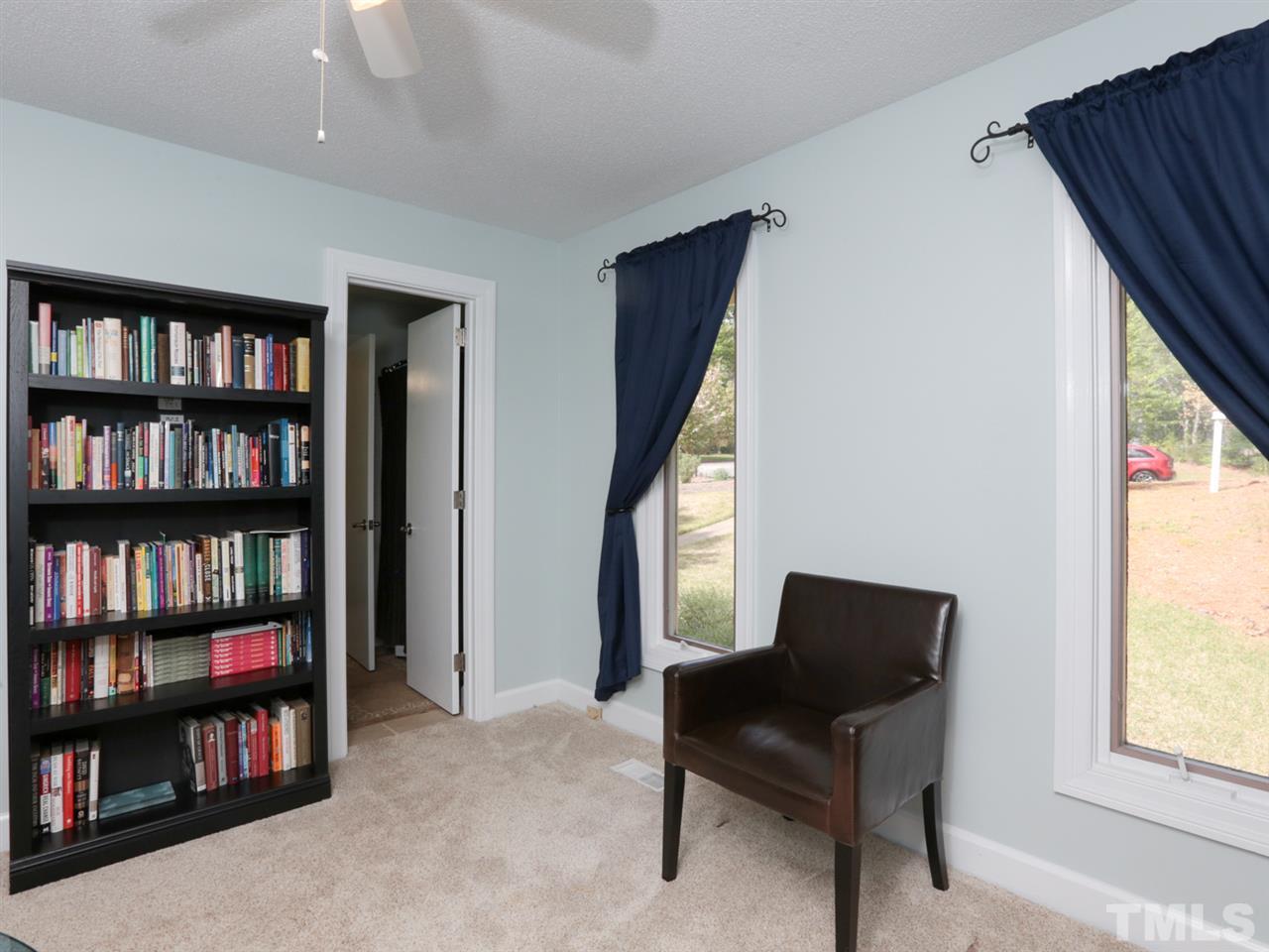 7309 Phellos Court Raleigh, NC 27615 - Photo 14 of 19 a living room with furniture and a book shelf