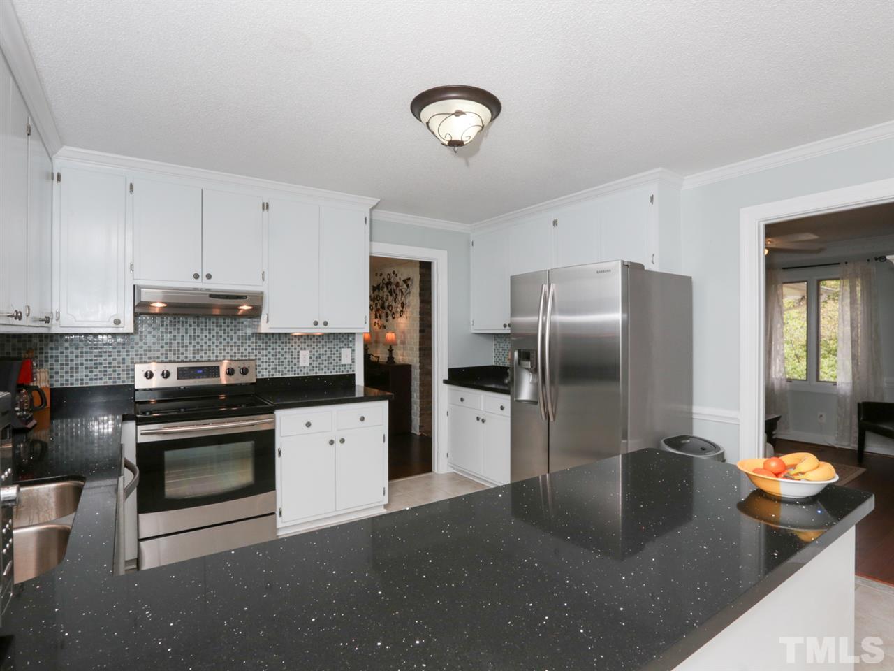 7309 Phellos Court Raleigh, NC 27615 - Photo 10 of 19 a kitchen with stainless steel appliances granite countertop a sink a stove and a refrigerator