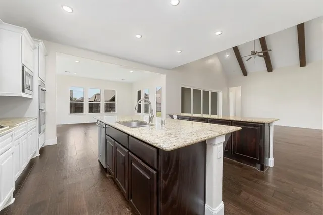 a kitchen with counter top space and wooden floor